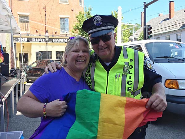 Auxiliary Police Officer with citizen during the Pride Parade