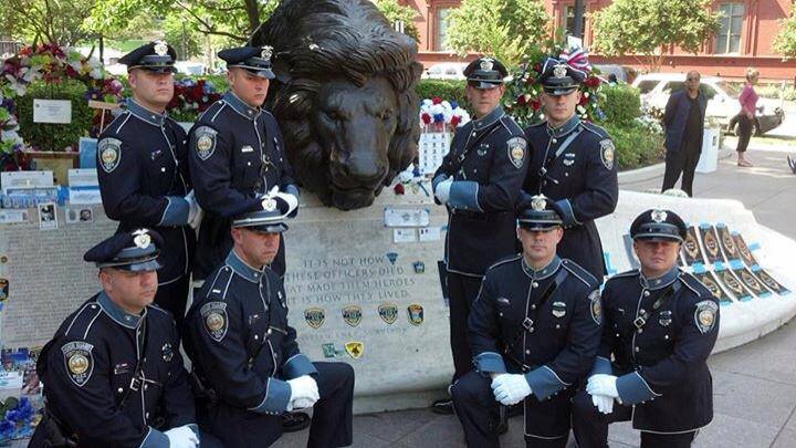 Honor Guard at memorial with lion head statue