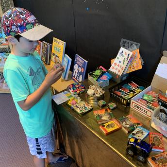 Child shopping in summer reading store