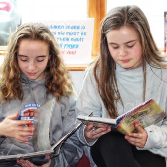 Two middle-schoolers reading