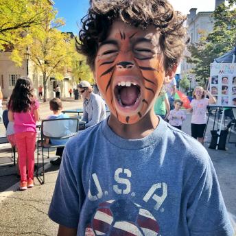 Boy in Market Square with tiger facepaint