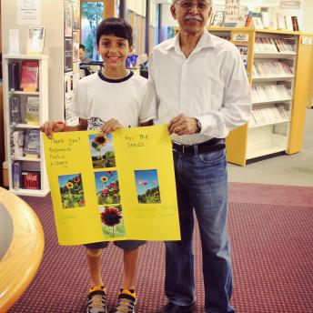 Father and son with homemade seed poster