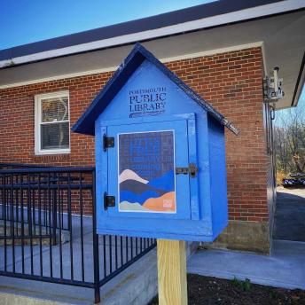 Little Free Library in front of Brick Building