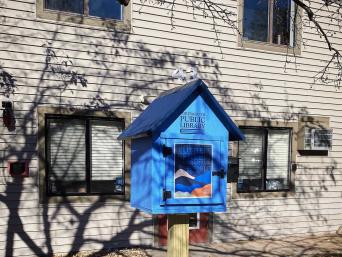 Little Free Library stands in front of a leasing office