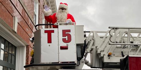 Santa Claus in Portsmouth FD ladder truck.