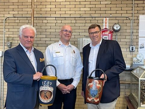 Federal and Mechanic Fire Societies present commemorative fire buckets to Chief McQuillen.