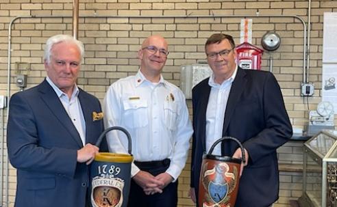 Federal and Mechanic Fire Societies present commemorative fire buckets to Chief McQuillen.